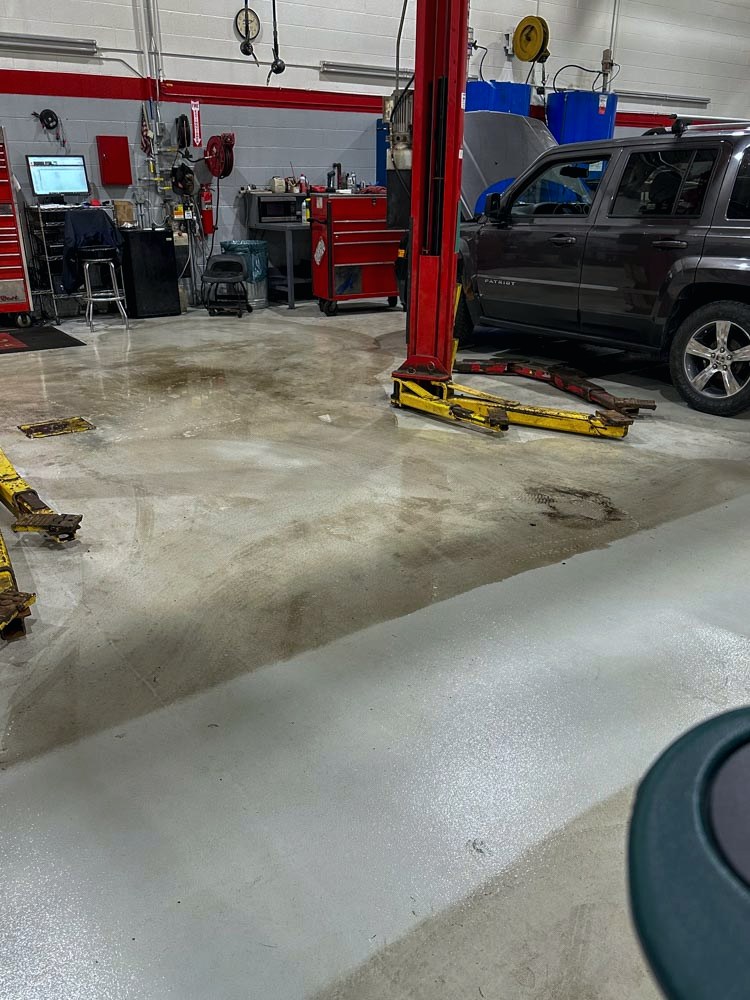 Service bay concrete floor before scrubbing and refinishing