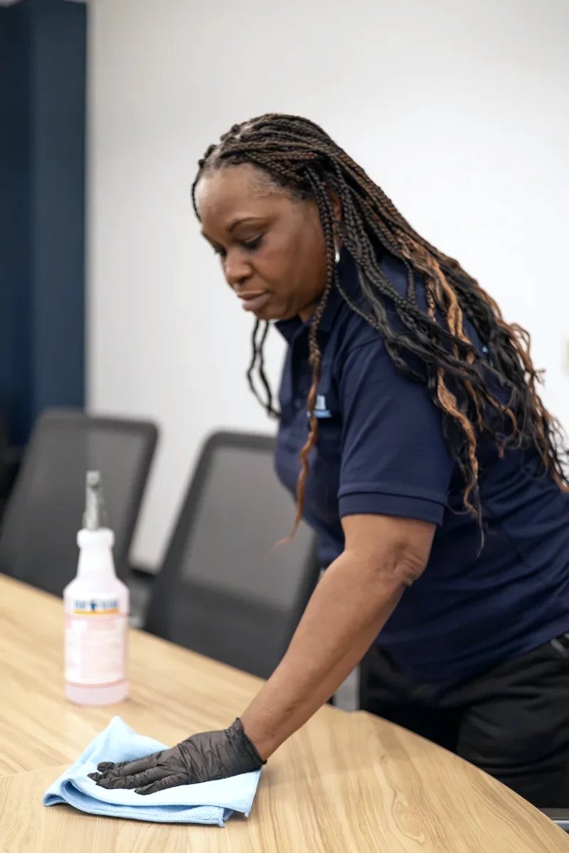 Stay Clean staff member detailing a conference room table